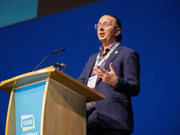 Ashley Ball-Gamble, CEO of CCLG, presenting in front of a podium at the 2025 CCLG Annual Conference