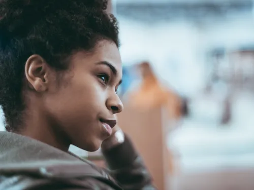 The face of a young woman looking thoughtful